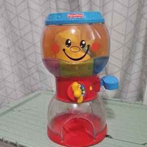 Fisher-Price Smiling Toy Dispenser with Red and Blue